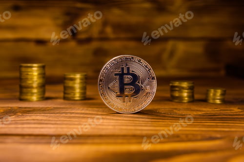 Preview: Bitcoin And Stack Of Coins On Rustic Wooden Table