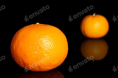 Preview: Group Of Two Whole Fresh Orange Mandarine Isolated On Black Glass