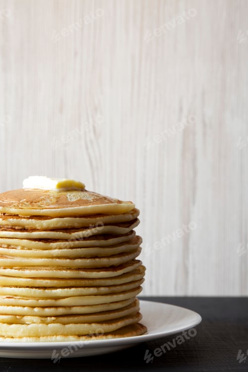 Preview: Homemade Pancakes With Butter On White Plate, Side View. Close-Up.