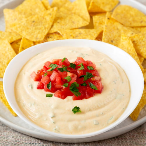 Preview: Homemade Cheesy Dip In A Bowl, Yellow Tortilla Chips, Side View. Closeup.
