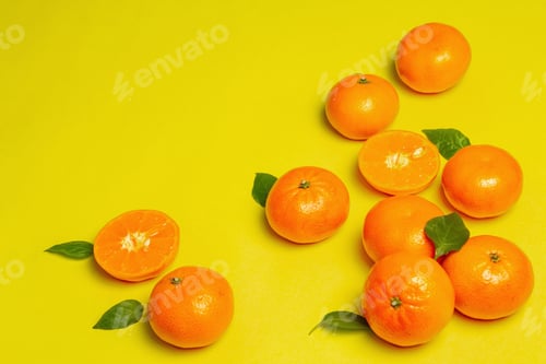 Preview: Ripe Juicy Tangerines And Fresh Leaves. Sunny Summer Yellow Background
