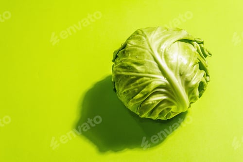 Preview: Fresh Young Cabbage, Whole Head In Bright Green Background. Modern Hard Light, Dark