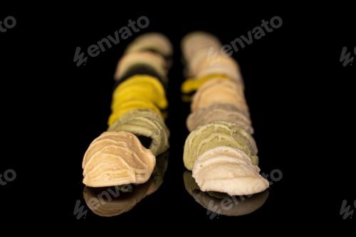 Preview: Lot Of Whole Colorful Pasta Orecchiette Isolated On Black Glass