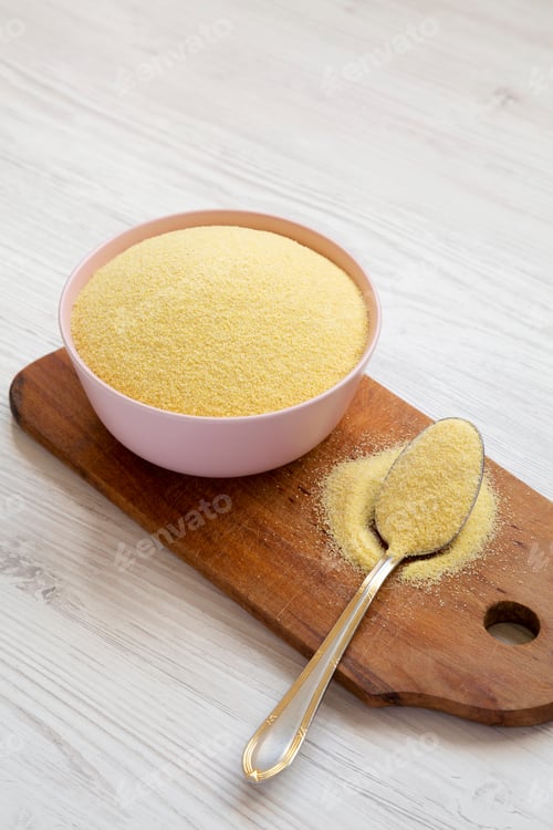 Preview: Dry Semolina Durum Flour In A Pink Bowl Over White Wooden Background, Side View.