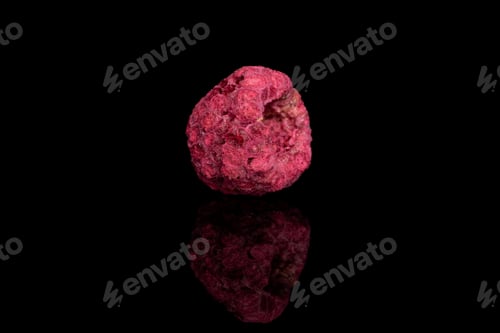 Preview: One Whole Dried Raspberry Isolated On Black Glass