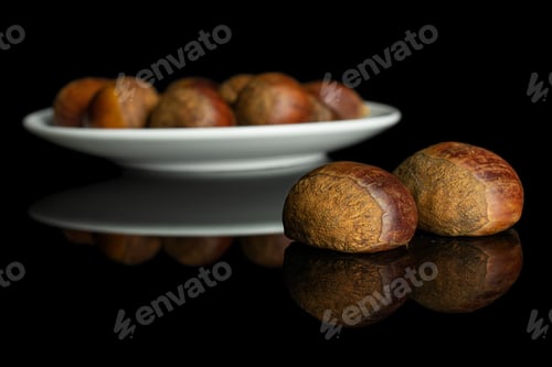 Preview: Lot Of Whole Sweet Brown Chestnut On White Ceramic Plate Isolated On Black Glass