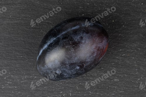 Preview: One Whole Fresh Purple Plum Flatlay On Grey Stone