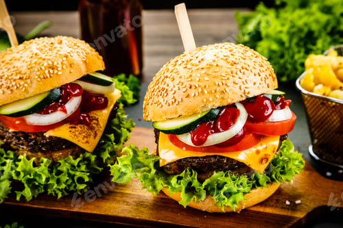 Preview: Tasty Burgers With Chips Served On Cutting Board On Stone Plate