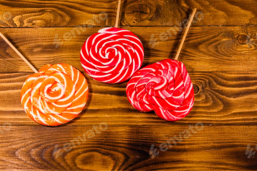 Preview: Big Sweet Lollipops On Rustic Wooden Table