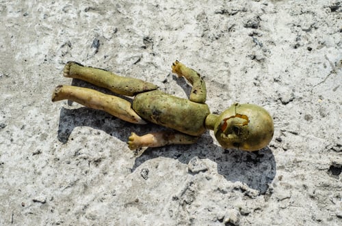 Preview: Old Broken Doll On A Concrete Structure