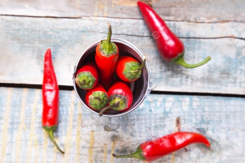 Preview: Few Ripe Pods Of Very Spice Pepper Are On A Wooden Background