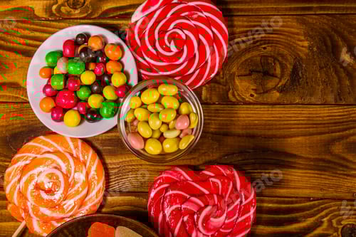 Preview: Different Sweet Candies On Rustic Wooden Table. Top View