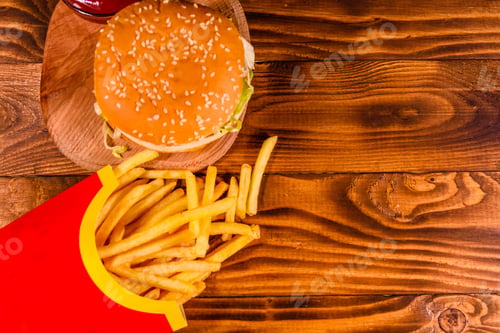 Preview: Hamburger And French Fries On Rustic Wooden Table. Top View