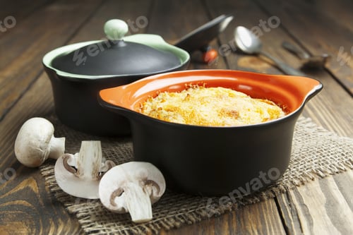 Preview: Casserole With Mushrooms And Cheese In The Pot On The Table