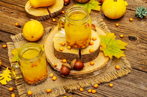 Preview: Vitaminic Healthy Sea Buckthorn Tea In Small Glass Jars With Fresh Berries And Autumn Decor. Fall