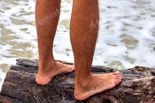 Preview: Legs Of A Man Standing On A Snag On The Seashore