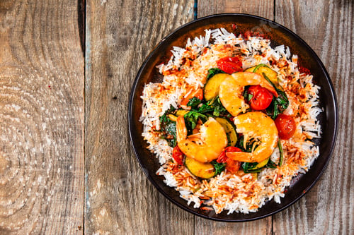 Preview: Shrimps With White Rice And Vegetables On Wooden Table