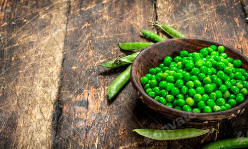 Preview: Fresh Green Peas In A Bowl. On A Wooden Background.