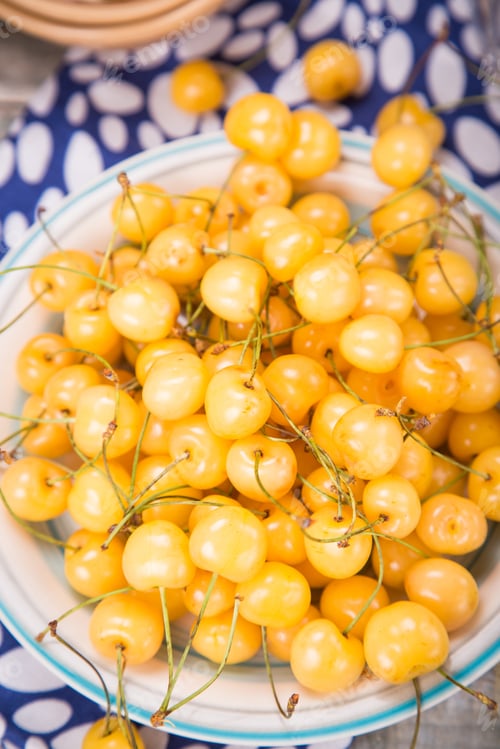 Preview: Fresh Ripe Raw Yellow Sweet Cherry On Colored Plate