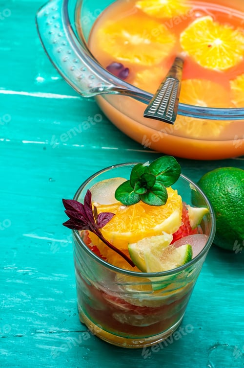 Preview: Glass Fresh Citrus Juice With Pulp On The Background Of The Vase With Juice
