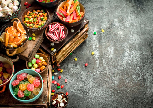 Preview: Various Sweets And Candied Fruits. On A Rustic Background.