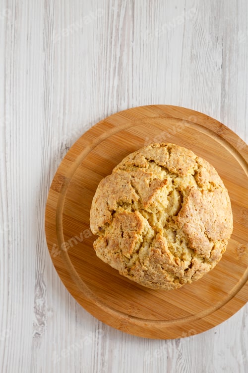 Preview: Homemade Irish Soda Bread On A Bamboo Board On A White Wooden Background, Top View. Flat Lay