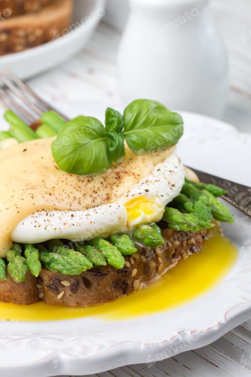 Preview: Bread Toast With Sesame And Flax Seed, Asparagus, Poached Egg And Hollandaise Sauce. A Traditional