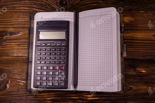 Preview: Opened Notepad, Scientific Calculator And Pencil On Rustic Wooden Table. Top View