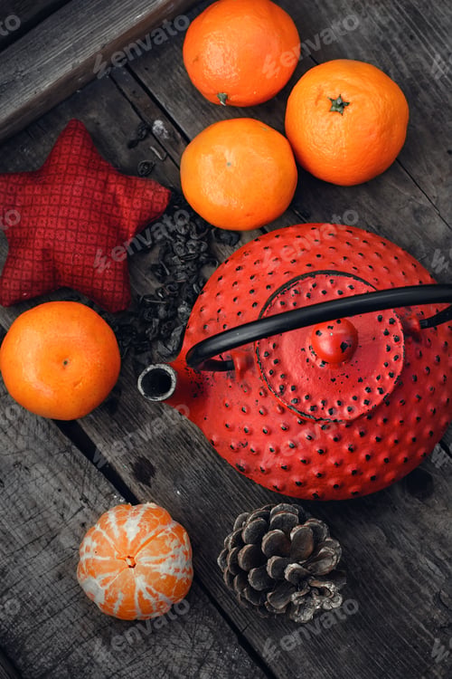 Preview: Red Cast Iron Teapot,Tangerine,Bump And Toy On Wooden Background