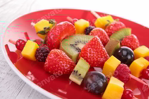Preview: Skewered Assorted Fruit on a Red Plate