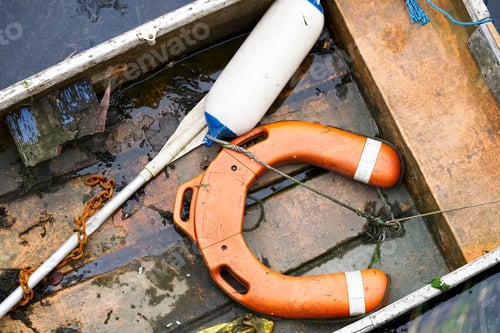 Preview: Orange Water Safety Buoy And Oar On Wooden Boat