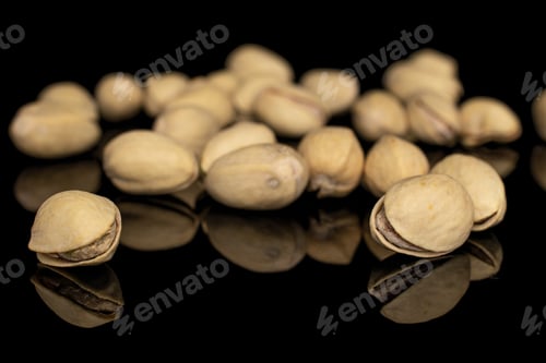 Preview: Lot Of Whole Disordered Salted Pistachio Isolated On Black Glass