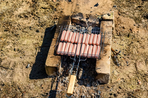 Preview: Sausages Cooking In Barbecue Grill On Campfire