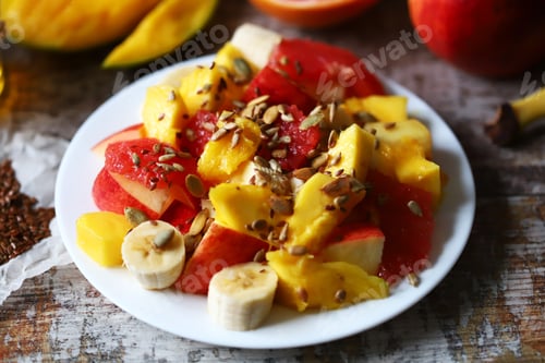 Preview: Fruit Salad On A White Plate. Healthy Salad With Fruits, Honey And Seeds. Healthy Dessert. Proper