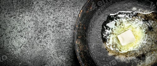 Preview: Butter In An Old Pan. On Rustic Background.