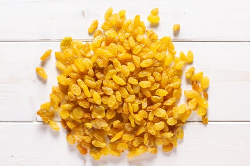 Preview: Lot Of Whole Dry Golden Raisins Sultana Variety Heap Flatlay On Grey Wood