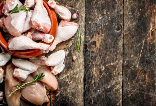 Preview: Various Types Of Raw Chicken Meat With Herbs In A Bowl. On Wooden Background.