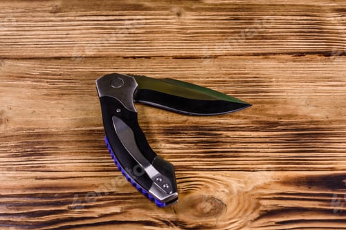 Preview: Opened Folding Knife On Rustic Wooden Table