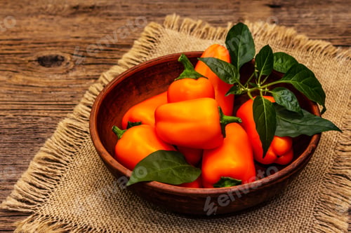 Preview: Ripe Whole Orange Mini Peppers In Clay Bowl. Fresh Harvest, Traditional Ingredient For Cooking