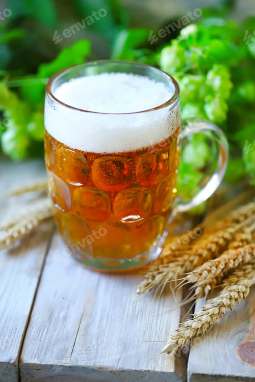 Preview: Selective Focus. A Glass Of Wheat Beer On A Wooden Surface. Wheat Ears And Hops.