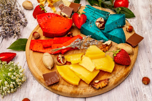 Preview: Cheese Plate. Assorted Multicolored Hard Dutch Cheeses. Blue And Red Pesto, Aged Gouda. Strawberry