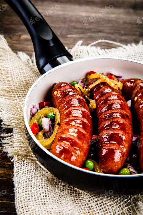 Preview: Grilled Sausages With Vegetables In Pan On Wooden Table