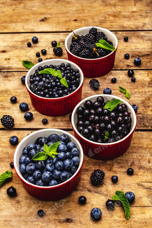 Preview: Assorted Berries In Blue And Black Colors: Bilberry, Blueberry, Currant And Blackberry. Old Wooden