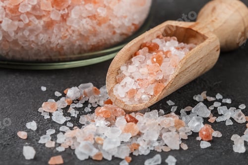 Preview: Himalayan Pink Salt In Wooden Spoon And Jar On A Black Background. Selective Focus