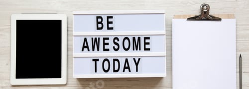 Preview: Workspace With Tablet, Clipboard And 'Be Awesome Today' Word On Modern Board Over White Wooden