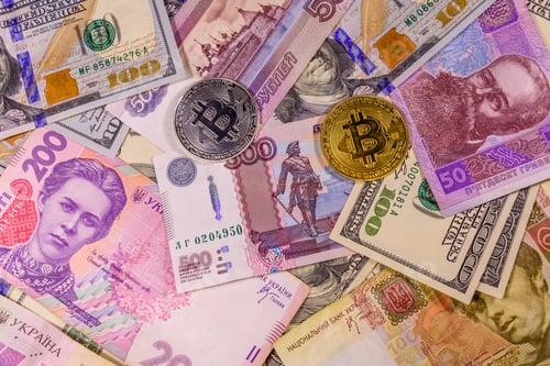 Preview: Bitcoin Coins On American, Ukrainian And Russian Banknotes