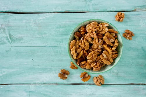 Preview: Walnuts In A Bowl On Turquoise Surface