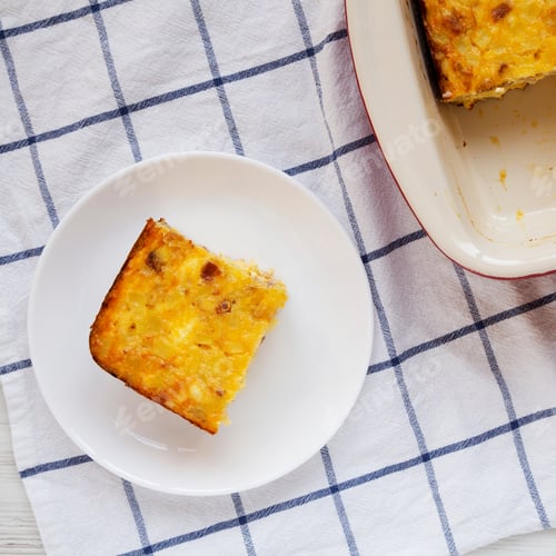 Preview: Home-Baked Cheesy Amish Breakfast Casserole On A White Plate, Top View. Flat Lay, Overhead, From