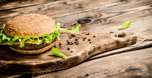Preview: A Burger On An Old Wooden Board With Spices. On Wooden Background.