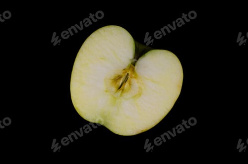 Preview: Half Of The Green Apple Isolated On Black Background